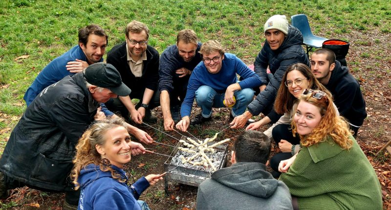 The Climate Policy Radar team around a campfire